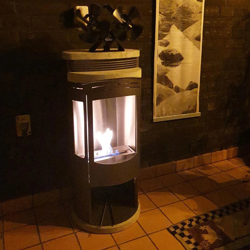 Deluxe Bio Burner 1,0L burning inside a freestanding stove at night
