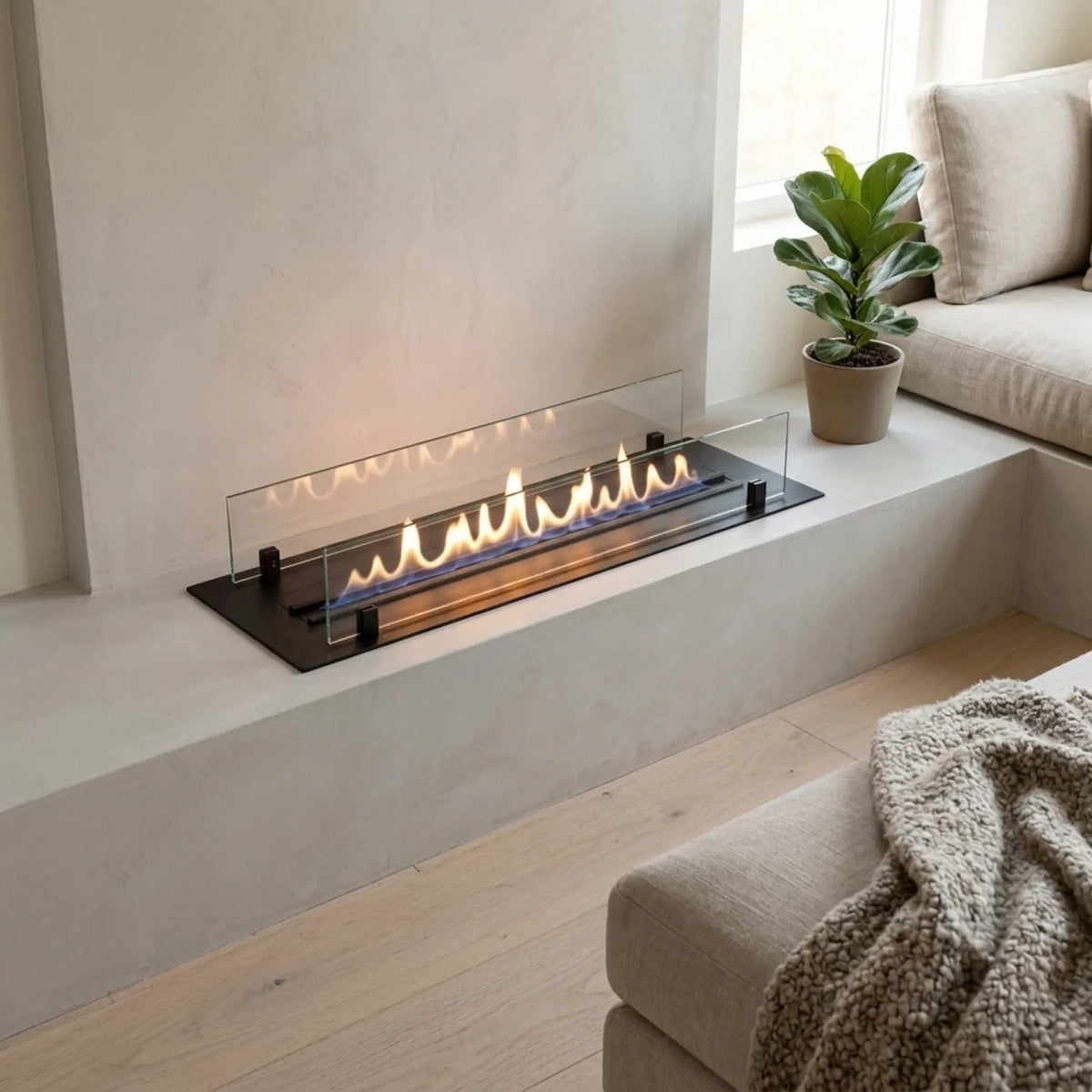 ScandiFlames Bioethanol Burner 990 in black built into a plastered fireplace ledge in a Scandinavian living room, lit flame